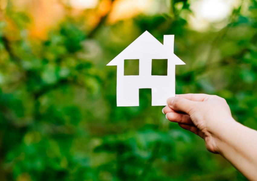 paper-house-cutout-with-hand-and-tree