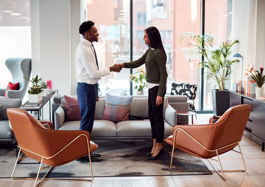 two-people-shaking-hands-near-seating